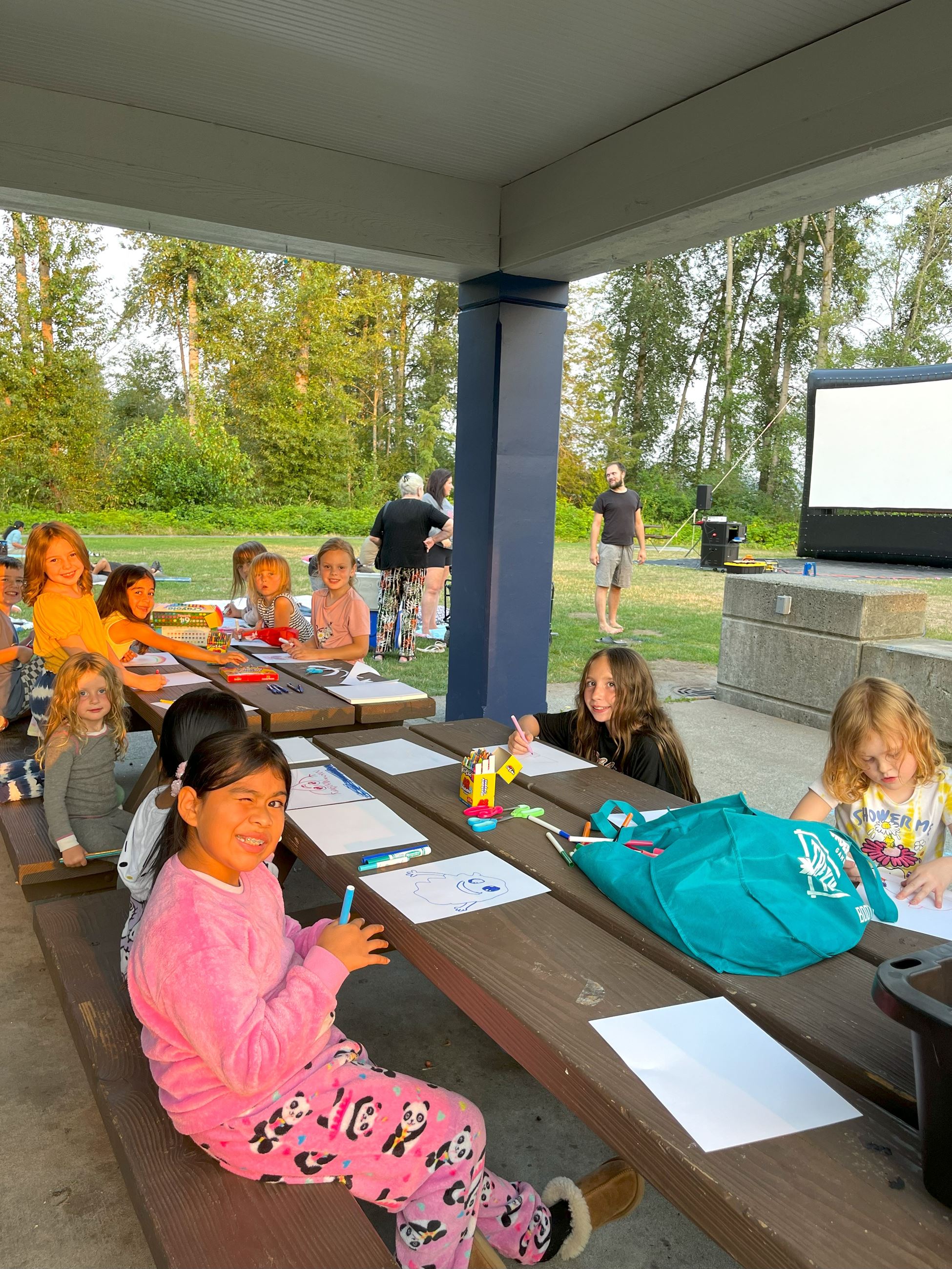 Kids coloring at table for Movies in the Park 