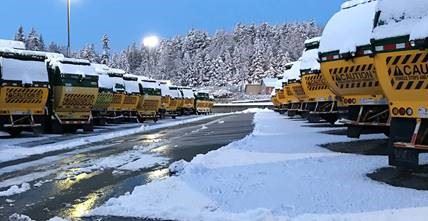 Waste Management Trucks covered in snow