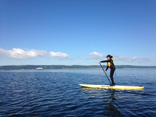 Hydrology Stand Up Paddle lessons with lady on paddle board